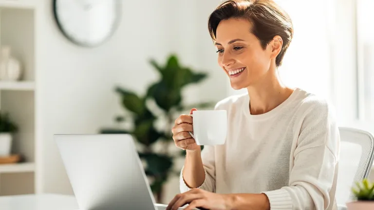 Person enjoying sustained energy and focus at work after optimizing caffeine intake