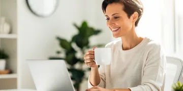 Person enjoying sustained energy and focus at work after optimizing caffeine intake
